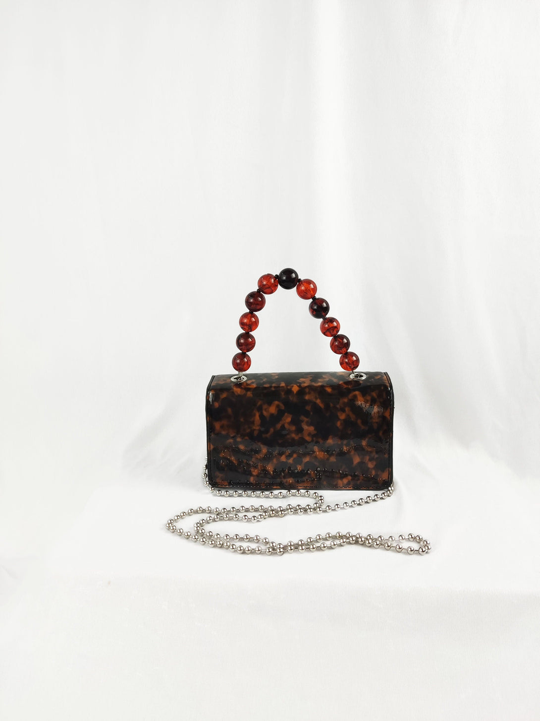 Camilla Tortoiseshell Crossbody Front Lapel Magnetic Clasp Handbag With Brown Beaded Acrylic Top Handle in Brown - Pink N' Proper